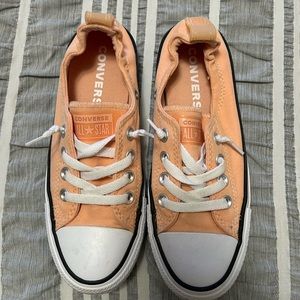 Peach colored low top converse